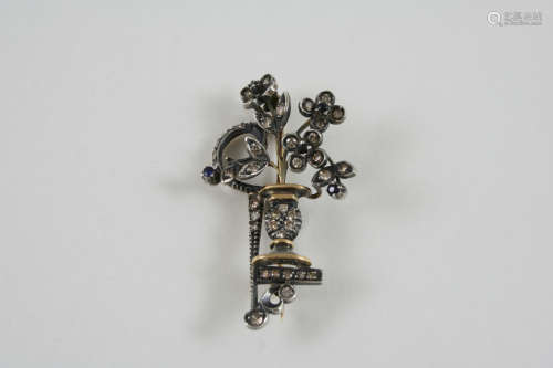 A SAPPHIRE AND DIAMOND BROOCH designed as a urn containing flowers and set overall with circular-cut