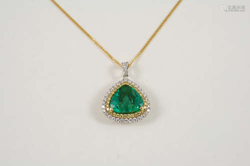 AN EMERALD AND DIAMOND CLUSTER PENDANT the pear-shaped emerald is set within a double surround of