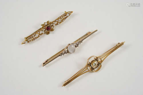 A DIAMOND AND GOLD BROOCH the openwork design is centred with a circular-cut diamond, 7cm. long,