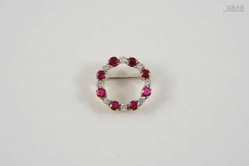 A RUBY AND DIAMOND CIRCLE BROOCH alternately set with circular-cut rubies and diamonds, in 18ct.
