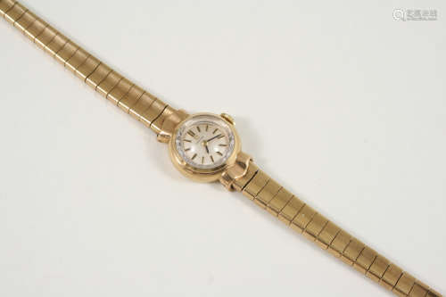 A LADY'S 9CT. GOLD WRISTWATCH BY OMEGA the signed circular dial with baton numerals, on a gold