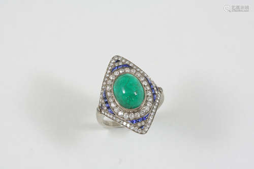 AN EMERALD, DIAMOND AND SAPPHIRE CLUSTER RING the oval cabochon emerald is set within a surround