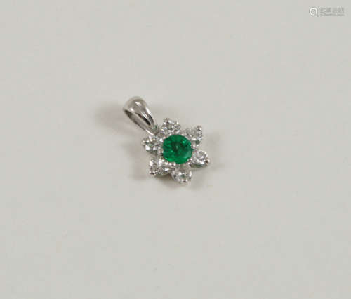 AN EMERALD AND DIAMOND CLUSTER PENDANT the circular-cut emerald is set within a surround of six