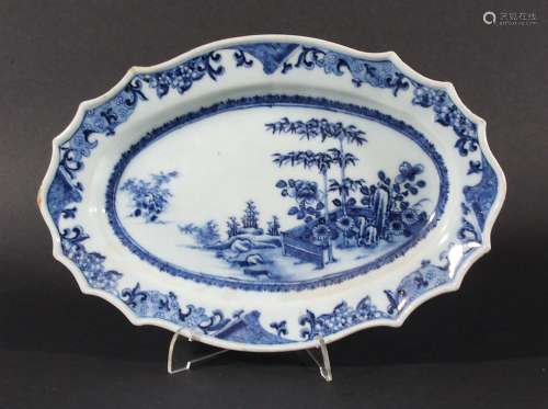 CHINESE OVAL DISH, 18th century, of shaped, slender oval form, painted with a fenced garden with