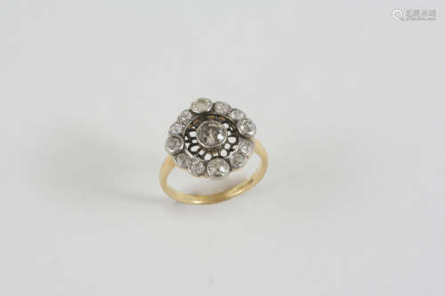 A DIAMOND CLUSTER RING the openwork design is centred with an old brilliant-cut diamond within a