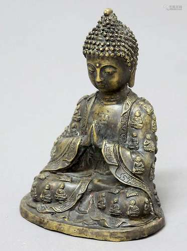 BRONZE BUDDHA, seated with hands together, a swastika on the chest, wearing a 1000 buddha robe,