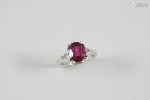 A RUBY AND DIAMOND THREE STONE RING the cushion-shaped ruby is set with a triangular-shaped