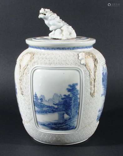 HIRADO STYLE JAR AND COVER, blue painted with landscape panels on a carved geometric ground, the
