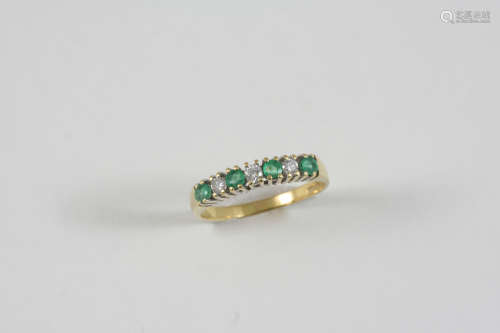AN EMERALD AND DIAMOND HALF HOOP RING alternately set with circular-cut diamonds and emeralds in