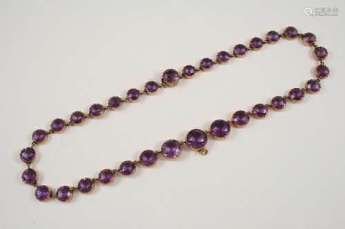 A VICTORIAN AMETHYST RIVIERE NECKLACE mounted with graduated circular-cut amethysts in gold cut down
