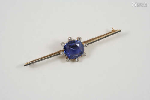 A SAPPHIRE AND DIAMOND BROOCH the cushion-shaped sapphire is set within a surround of circular-cut