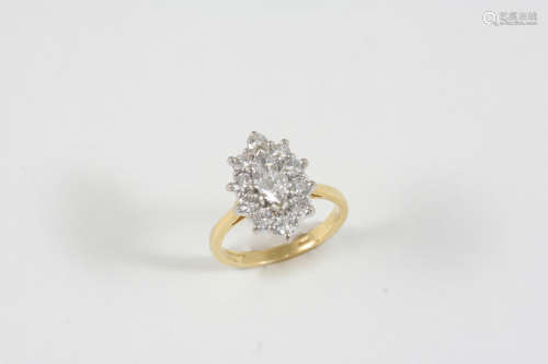 A DIAMOND CLUSTER RING the central marquise-cut diamond is set within a surround of ten circular-cut