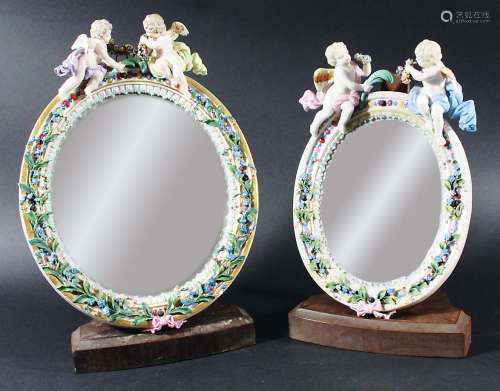 MEISSEN MIRROR, the oval plate in a frame surmounted by a pair of cherubs, blue crossed swords,
