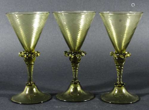 SET OF EIGHT VENETIAN STYLE WINE GLASSES, pale olive green, the conical bowls with wrythen