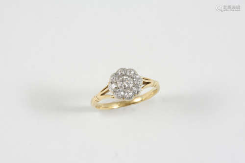 A DIAMOND CLUSTER RING the central old brilliant-cut diamond is set within a surround of smaller old