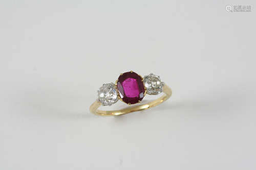 A RUBY AND DIAMOND THREE STONE RING the oval-shaped ruby is set with two old brilliant-cut diamonds,