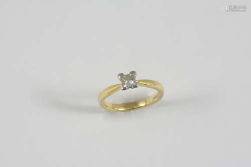 A DIAMOND SOLITAIRE RING set with a square-shaped diamond in 18ct. gold. Size L.
