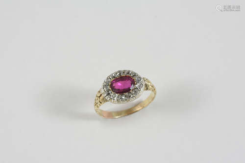 A RUBY AND DIAMOND CLUSTER RING the oval-shaped ruby is set within a surround of cushion-shaped