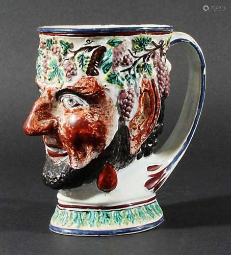 PEARLWARE SATYR MUG, circa 1800, moulded with fruiting vines to the rim, height 15cm
