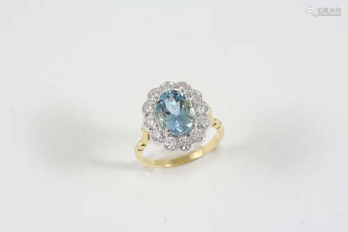 AN AQUAMARINE AND DIAMOND CLUSTER RING the oval-shaped aquamarine is set within a surround of twelve