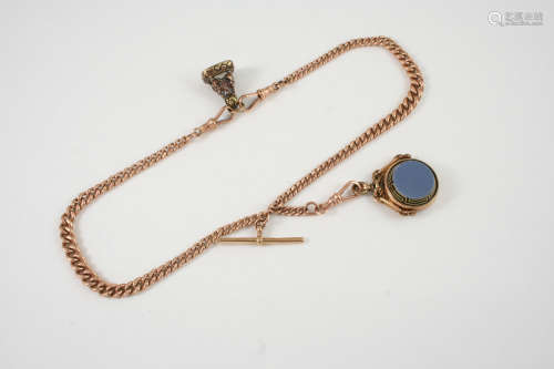 A 9CT. GOLD WATCH CHAIN suspending a 9ct. gold spinning fob and another seal, 35cm. long, total