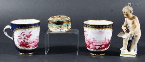 PAIR OF SEVRES STYLE COFFEE CUPS, 19th century, puce painted with rural scenes inside gilt frames