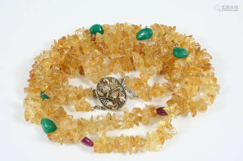 A TWO ROW CITRINE AND GEM SET NECKLACE the sections of citrine are mounted with emerald and ruby