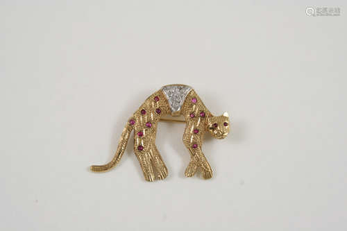A GOLD AND GEM SET LEOPARD BROOCH set with circular-cut diamonds and rubies, in 9ct. gold, 4cm.