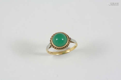 A CHRYSOPRASE SINGLE STONE RING set with a circular chrysoprase cabochon, in 18ct. gold and