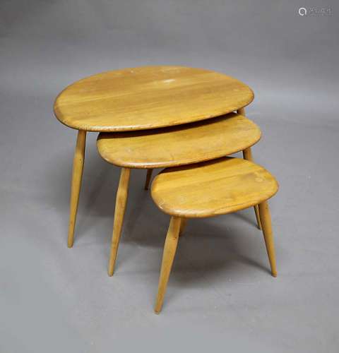 ERCOL 'PEBBLE' NEST OF TABLES a set of three light coloured elm 'Pebble' coffee tables, also with