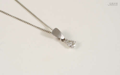 A DIAMOND SOLITAIRE PENDANT set with a diamond pear-shaped drop in 18ct. white gold, on a fine