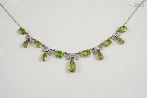 A BELLE EPOQUE PERIDOT AND DIAMOND NECKLACE formed with graduated rectangular-shaped peridots,