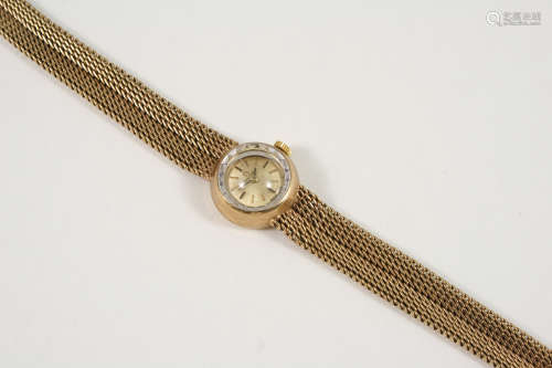 A LADY'S 9CT. GOLD WRISTWATCH BY OMEGA the signed circular dial with baton numerals, on an