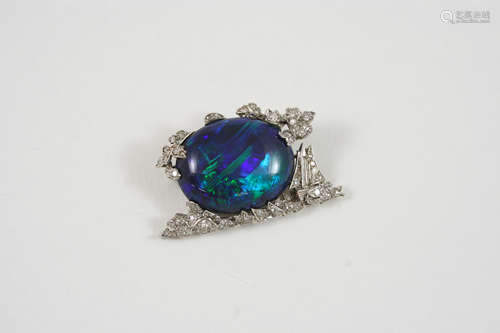 AN EARLY 20TH CENTURY BLACK OPAL AND DIAMOND BROOCH the oval-shaped solid black opal is set within a