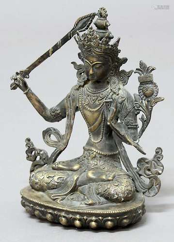 BRONZE BODHISATTVA MANJUSHRI, seated on a lotus plinth, possibly with the remains of some silvering,