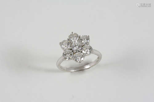 A DIAMOND CLUSTER RING the flowerhead design is set with brilliant-cut diamonds in 18ct. white gold.