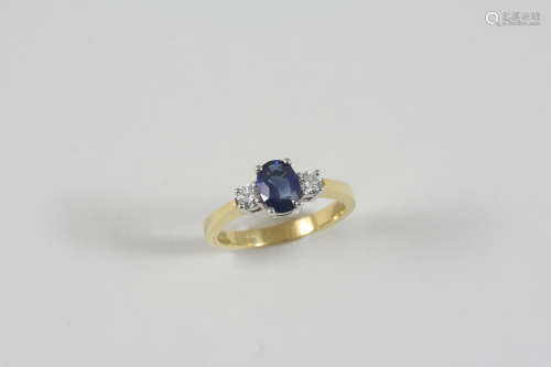 A SAPPHIRE AND DIAMOND THREE STONE RING the oval-shaped sapphire is set with two circular-cut