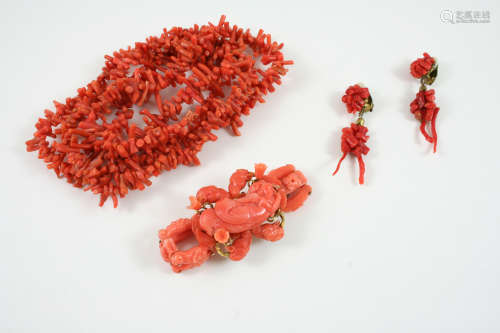 A CARVED CORAL BRACELET depicting an angel amongst foliate, 14.5cm. long, together with a single row