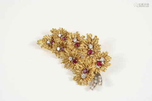 A GOLD, RUBY AND DIAMOND BROOCH the foliate spray design is mounted with circular-cut diamonds and
