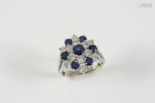 A SAPPHIRE AND DIAMOND CLUSTER RING the flowerhead design is set overall with circular-cut sapphires