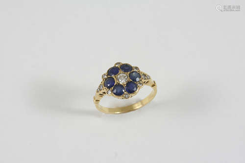 A SAPPHIRE AND DIAMOND CLUSTER RING the flowerhead design is mounted with circular-cut sapphires and