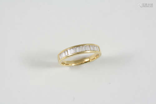 A DIAMOND HALF HOOP RING the 18ct. gold ring is set with slightly graduated baguette-cut diamonds.