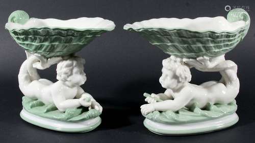 PAIR OF MINTON TAZZAE, date cypher for 1868, modelled as mer-children supporting shells, in pale