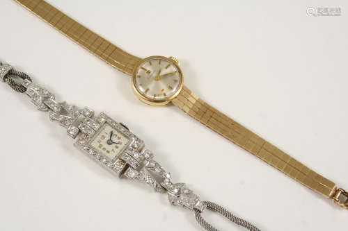 A LADY'S 9CT. GOLD WRISTWATCH BY TISSOT the signed circular dial with baton numerals, on an