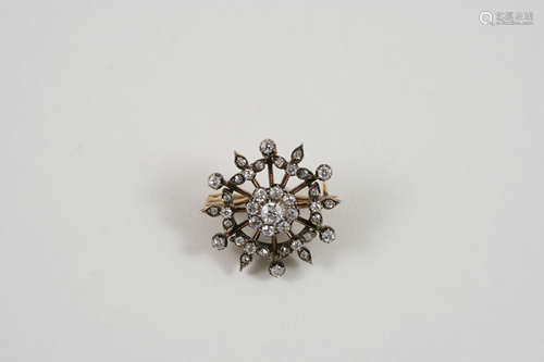 A VICTORIAN DIAMOND BROOCH PENDANT of openwork flowerhead form, set overall with graduated old