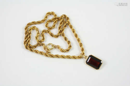 A SINGLE STONE GARNET PENDANT the rectangular-shaped garnet is set in a gold mount, on an 18ct. gold