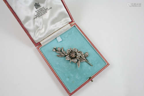 A VICTORIAN FANCY COLOURED AND WHITE DIAMOND FOLIATE BROOCH the flowerhead is centred with a