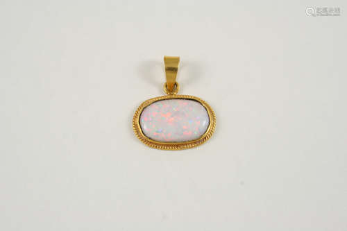 AN OPAL SINGLE STONE PENDANT the oval-shaped solid white opal is set in a gold mount, 2.5cm. wide.