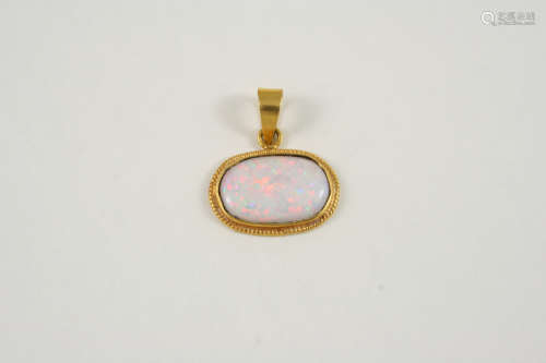 AN OPAL SINGLE STONE PENDANT the oval-shaped solid white opal is set in a gold mount, 2.5cm. wide.
