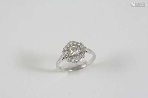 A DIAMOND CLUSTER RING the central circular-cut diamond is set within a surround of two baguette-cut